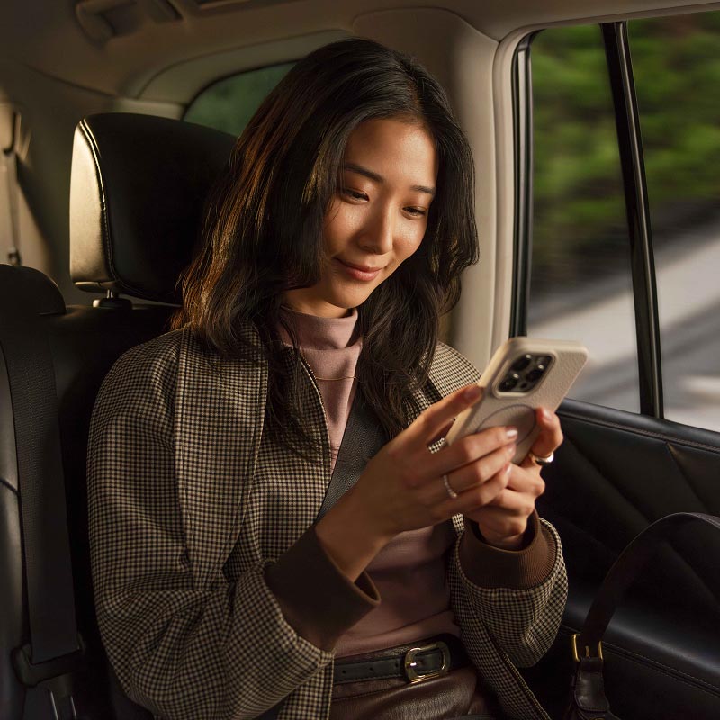woman using her phone inside car